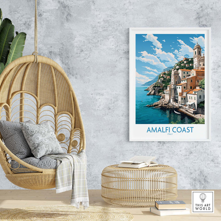 Amalfi Coast poster displayed in modern decor with hanging chair and rattan table, showcasing Italian landscape and pastel colors.