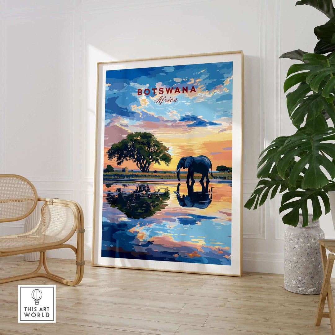 Botswana Elephant Sunset Art Print featuring an elephant by a serene water reflection.