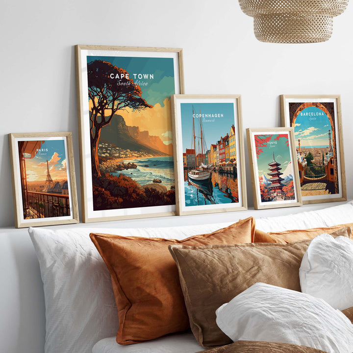 Cape Town print featured among framed travel posters on a stylish bed, enhancing home decor with elegance.