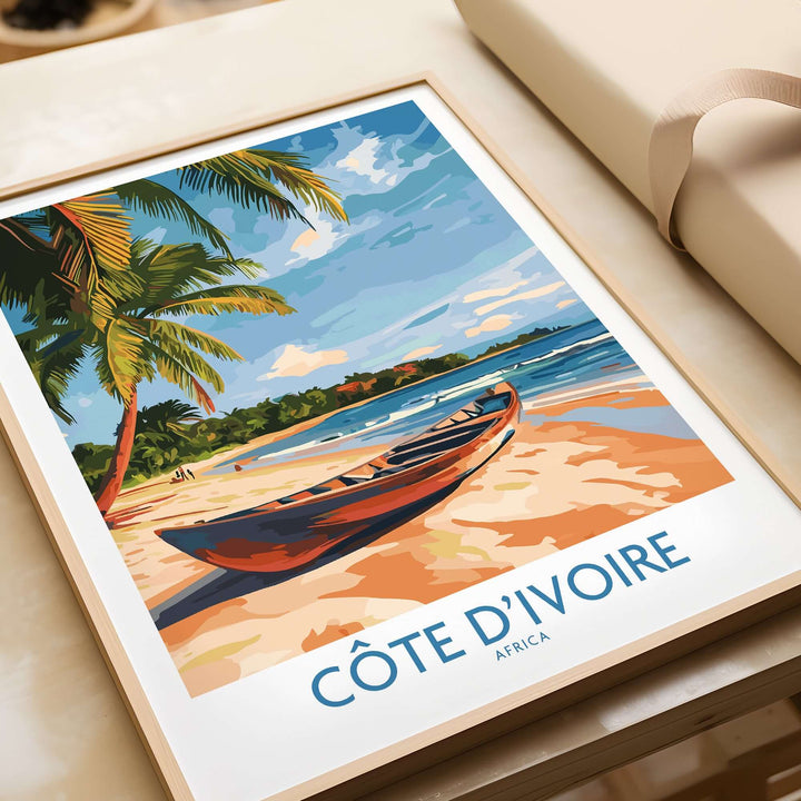 Côte d'Ivoire travel print featuring a serene beach scene with palm trees and a canoe, perfect for home decor.