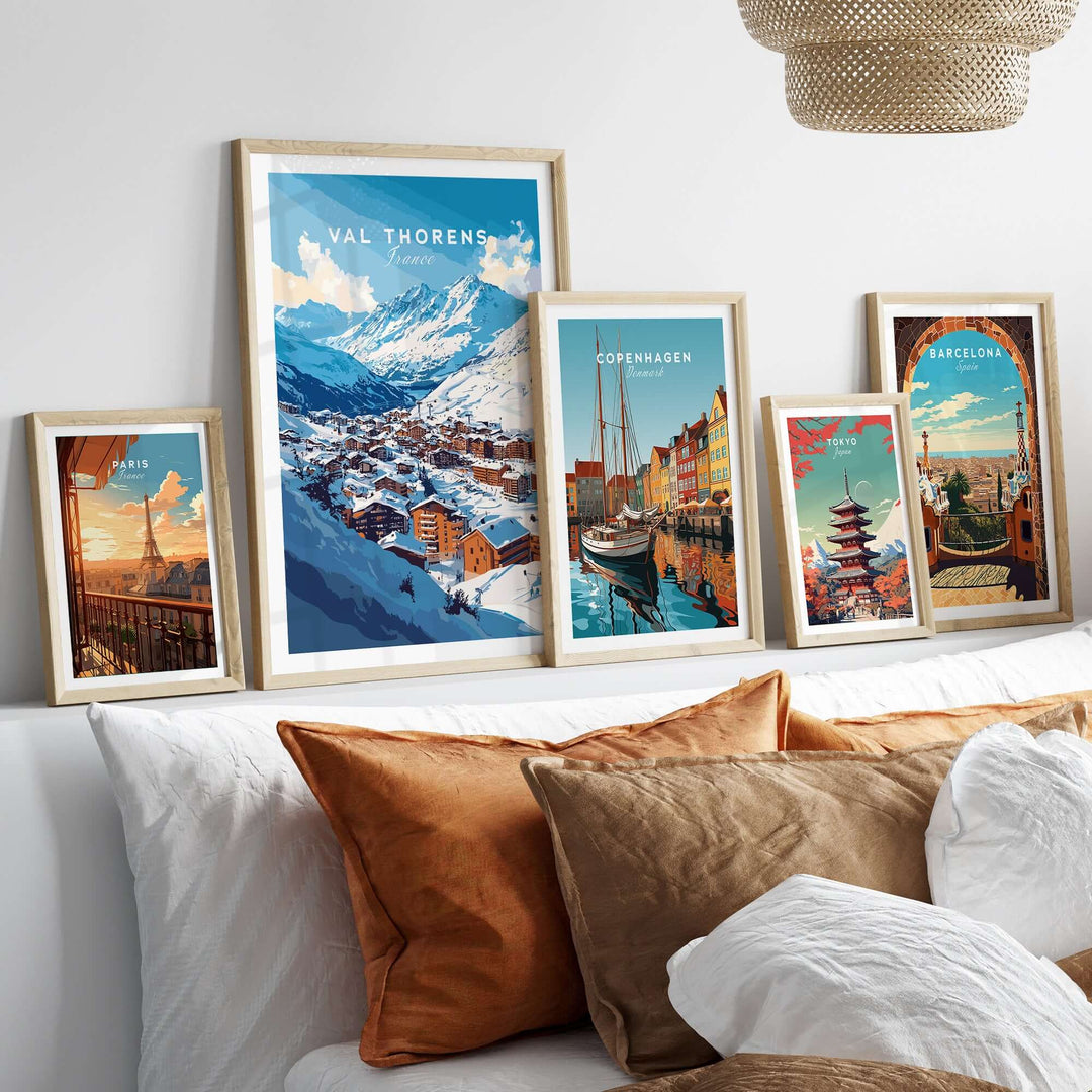 Val Thorens ski village posters displayed on a wall above a cozy bed with decorative pillows.