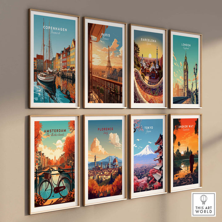 Colorful travel poster prints of Barcelona, Paris, Copenhagen, London, Amsterdam, Florence, Tokyo, and Bangkok displayed on a wall.