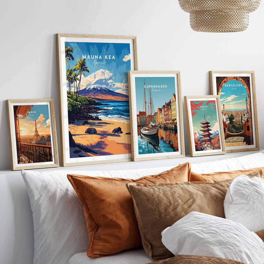 Framed Hawaii Coastal Art prints, including Mauna Kea Beach, displayed on a wall above a cozy couch.