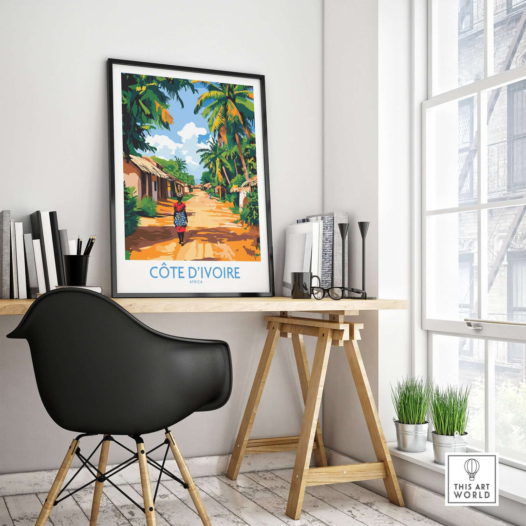 Côte d'Ivoire travel poster displayed in a modern workspace, showcasing vibrant African art and culture.