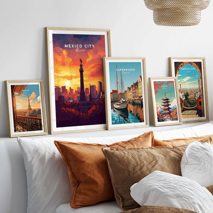 Framed travel prints including Mexico City El Ángel, Copenhagen, and Barcelona displayed on a stylish home decor shelf.