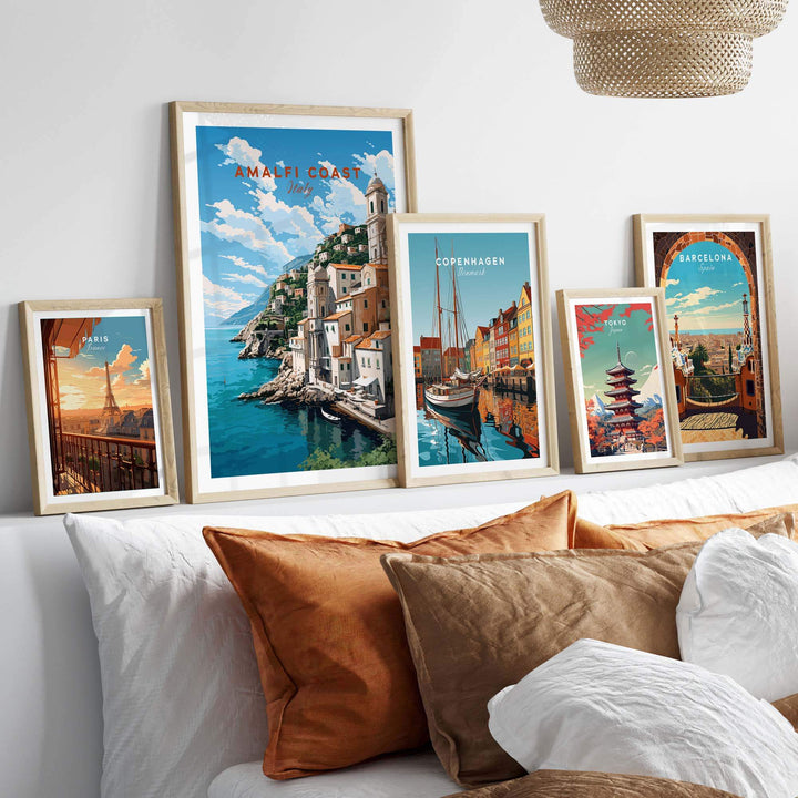 Amalfi Coast Italy travel poster among framed prints of cities, enhancing the decor with vivid travel visuals.