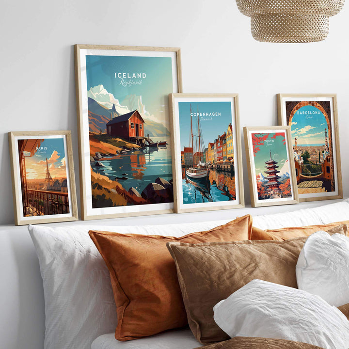 Iceland Poster Reykjavik among other travel posters, stylishly displayed on a cozy wall above decorative cushions.