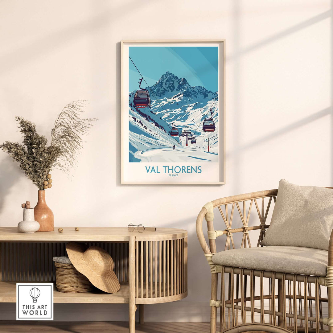 Winter sports poster of Val Thorens ski resort hanging on wall near a stylish chair and decor.