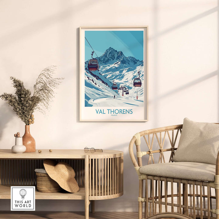 Winter sports poster of Val Thorens ski resort hanging on wall near a stylish chair and decor.