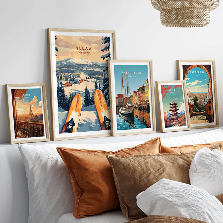 Ylläs Ski Resort print and various travel posters displayed on a stylish bed with decorative pillows.