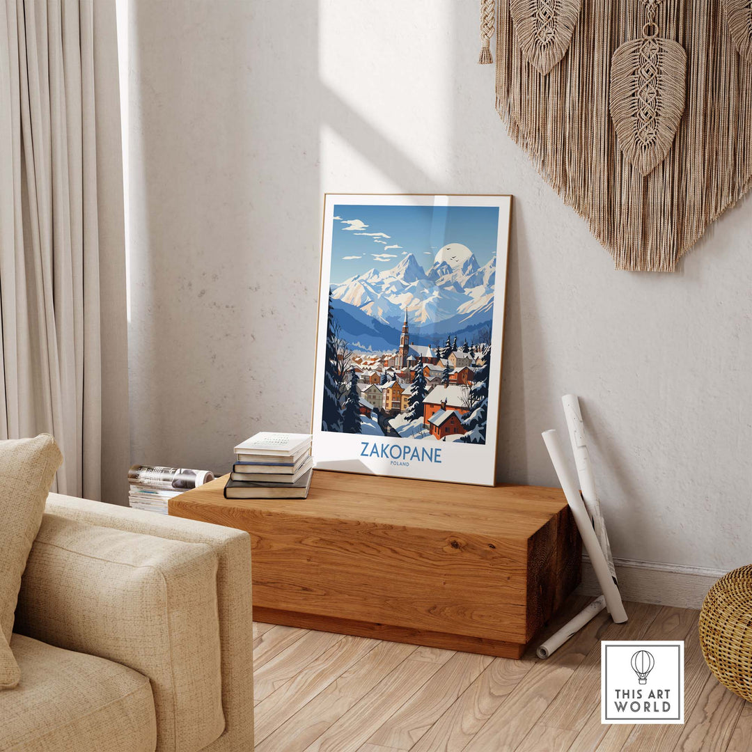 Zakopane travel poster featuring snowy mountains and a cozy town scene, displayed in a stylish living room setting.
