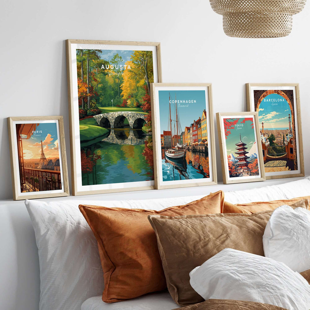 Framed travel prints of Augusta, Copenhagen, Barcelona, and more, displayed elegantly on a cozy couch.
