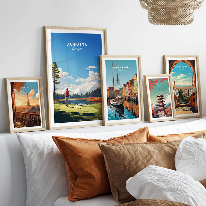 A stylish display of framed travel posters featuring Augusta, Copenhagen, and Barcelona, set in a cozy living room.
