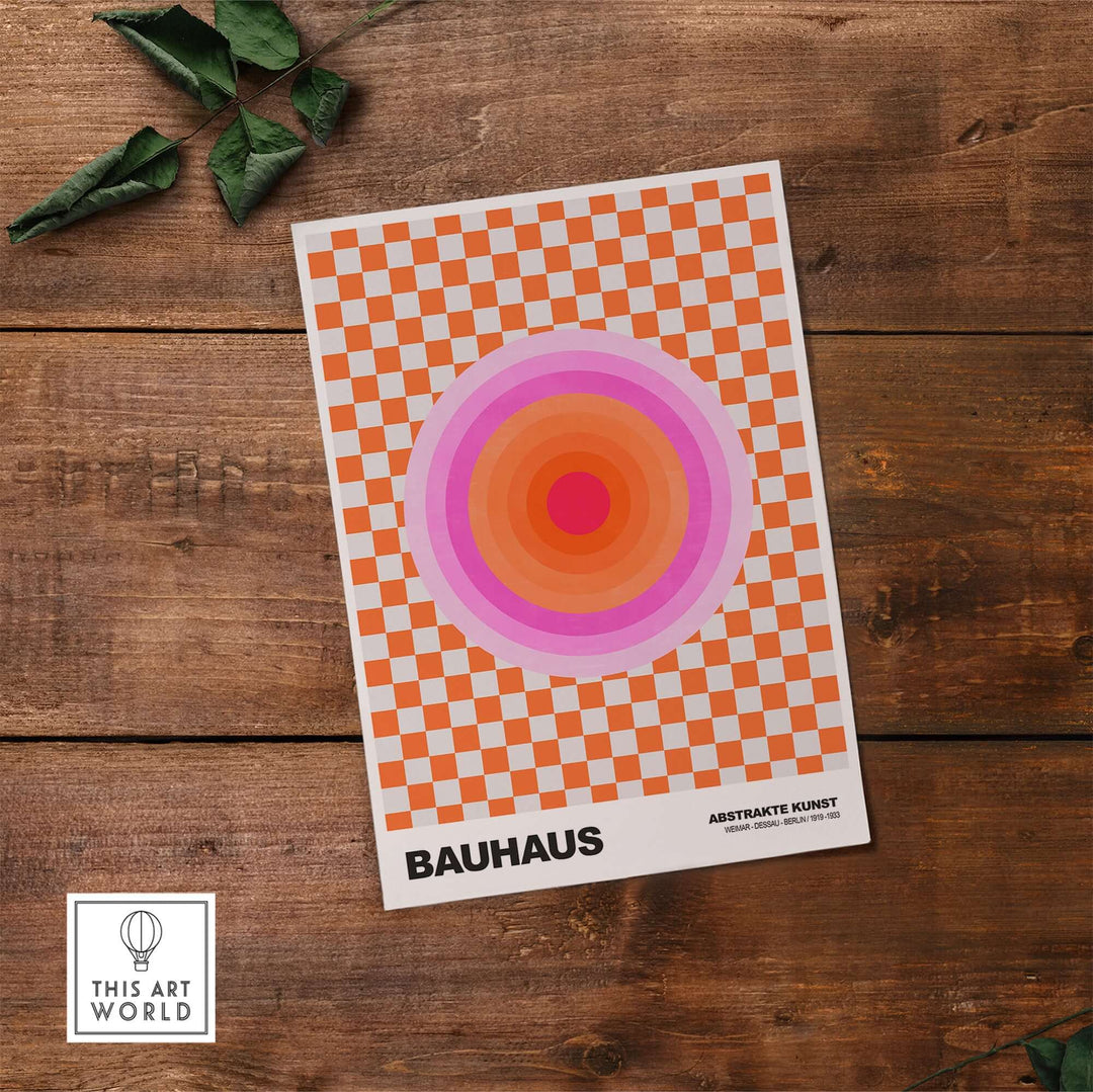 Bauhaus exhibition print featuring pink circles and an orange checkerboard pattern on a wooden background.
