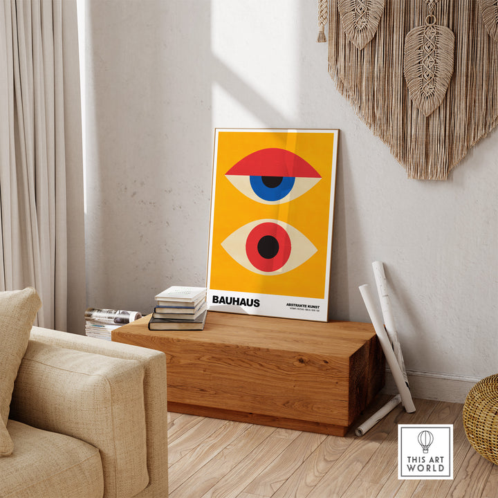 Bauhaus abstract eyes poster in orange and blue displayed in a modern interior setting with wooden accents.