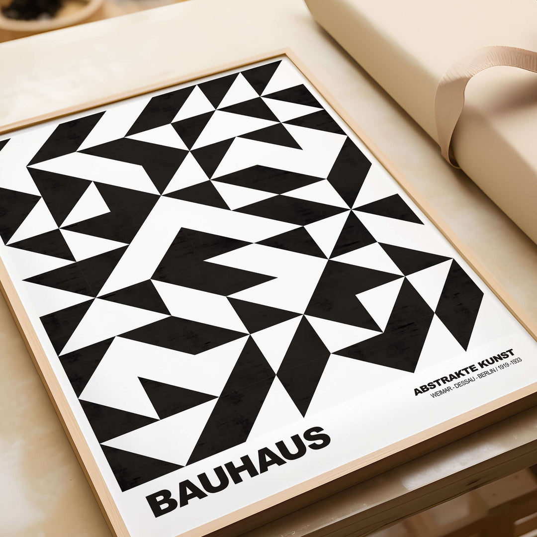 Bauhaus exhibition print featuring a black and white geometric triangle pattern in a modern frame.