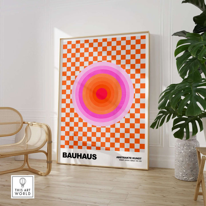 Bauhaus Exhibition Print featuring pink circles and orange checkerboard art in a modern living space.