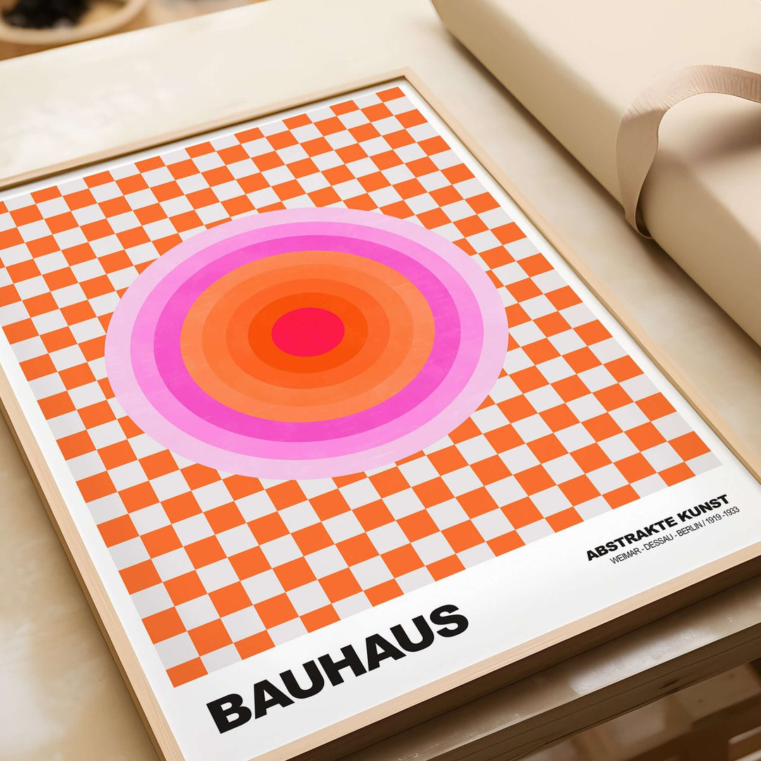Bauhaus art print featuring concentric pink and orange circles over an orange and grey checkerboard background.
