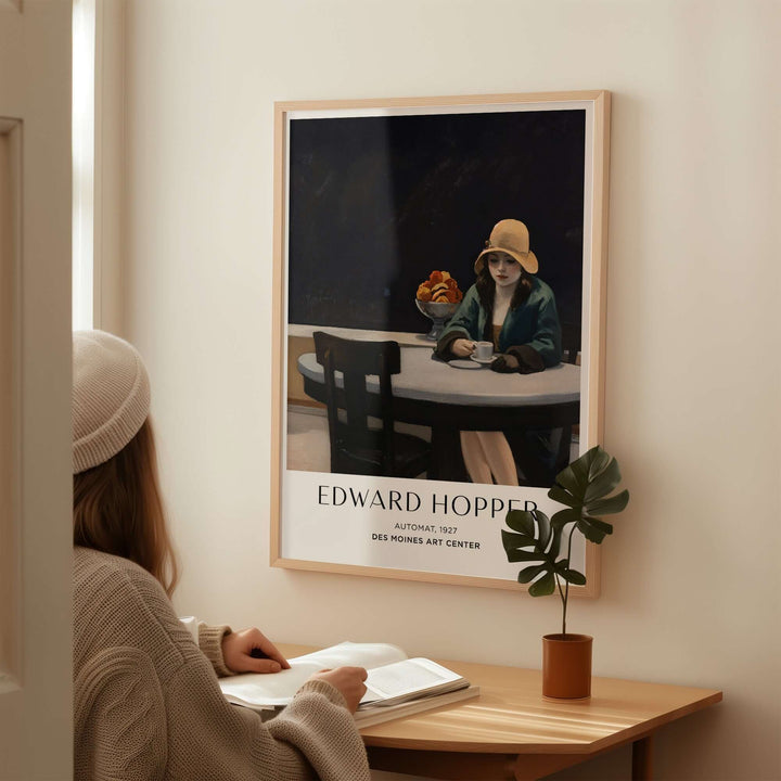 Edward Hopper Automat 1927 art print displayed in a cozy setting, featuring a woman and a potted plant.