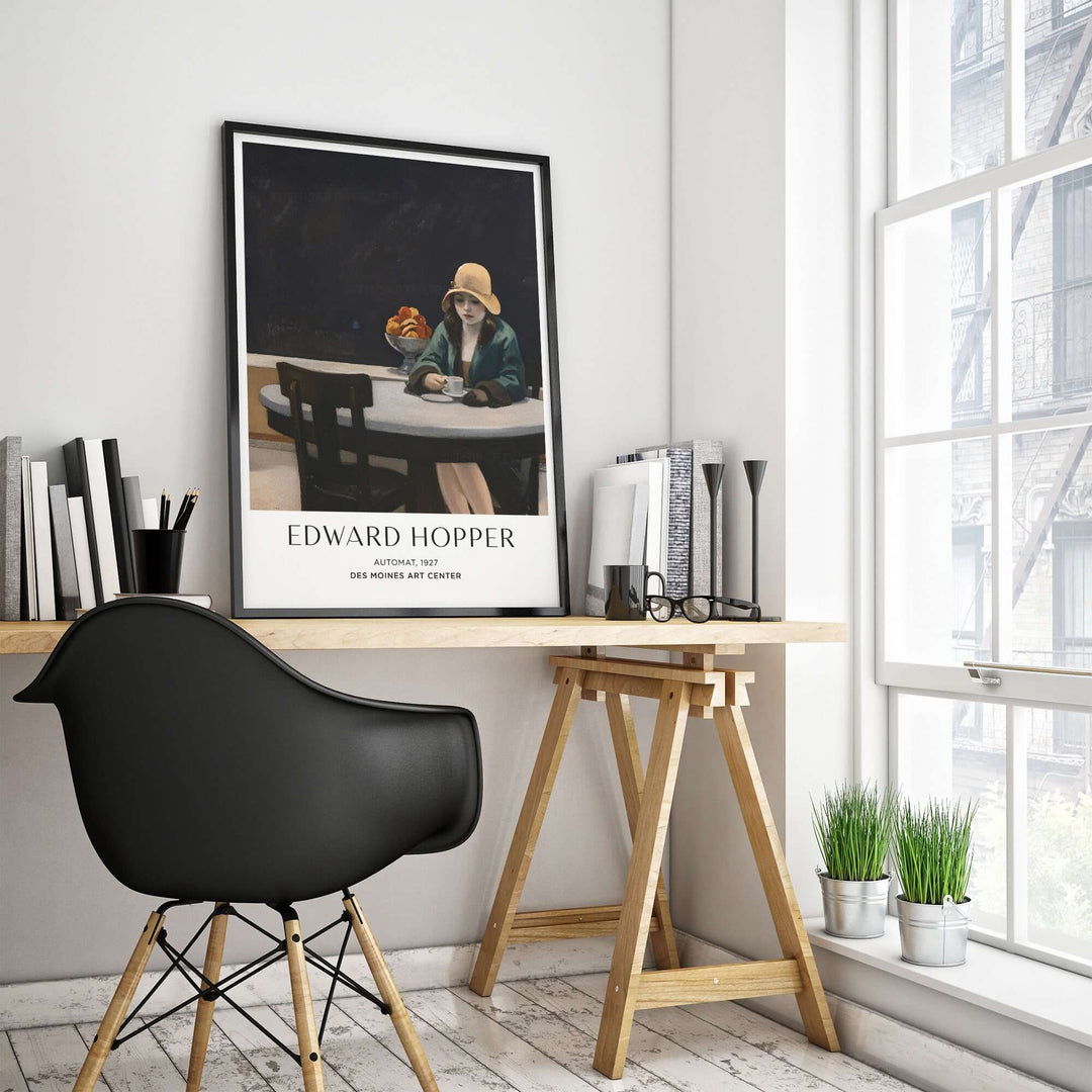 Edward Hopper Automat 1927 poster print displayed in a modern workspace featuring a black chair and natural light.