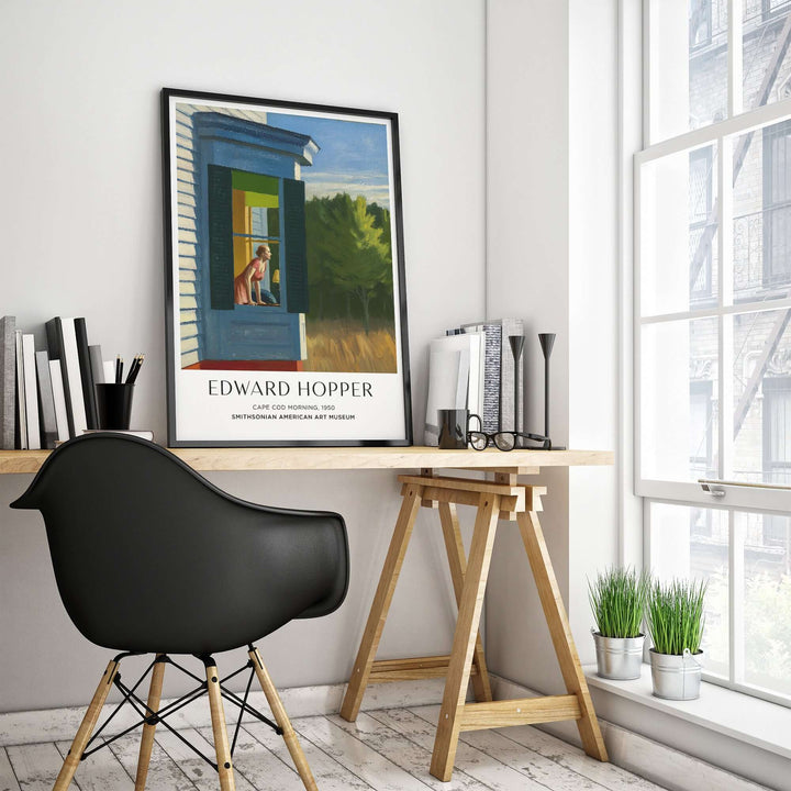 Edward Hopper Cape Cod Morning art print poster displayed in a modern home office with sunlight and plants.