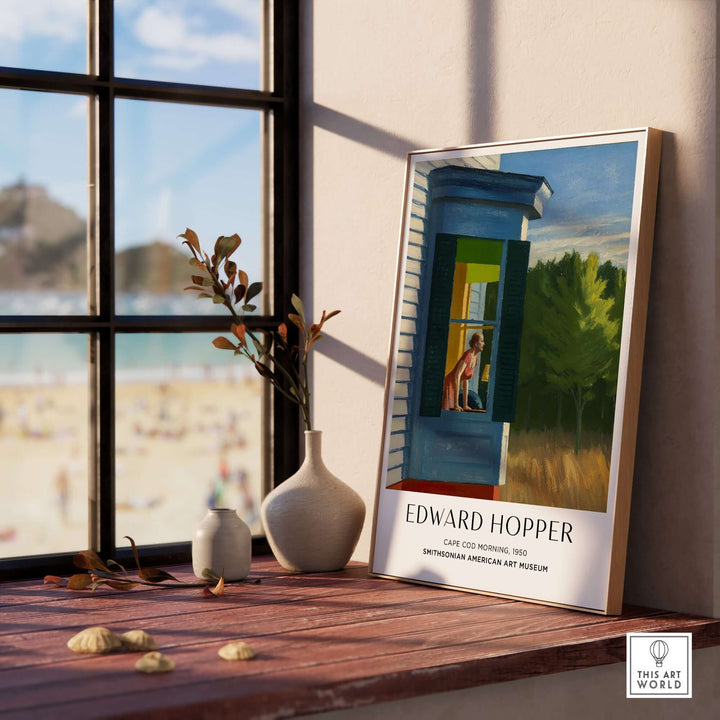 Edward Hopper Cape Cod Morning 1950 art print poster displayed by a sunlit window with beach view.