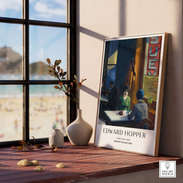 Edward Hopper Chop Suey 1929 art print poster displayed in a cozy setting with a beach view.