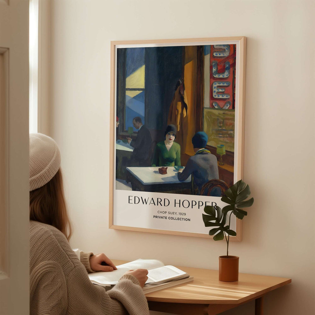 Woman admiring Edward Hopper's Chop Suey 1929 art print in a cozy urban setting.