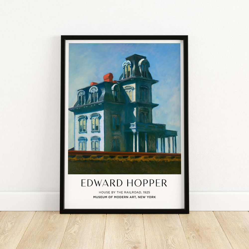 Edward Hopper House by the Railroad 1925 art print poster framed on wall, iconic American art piece.