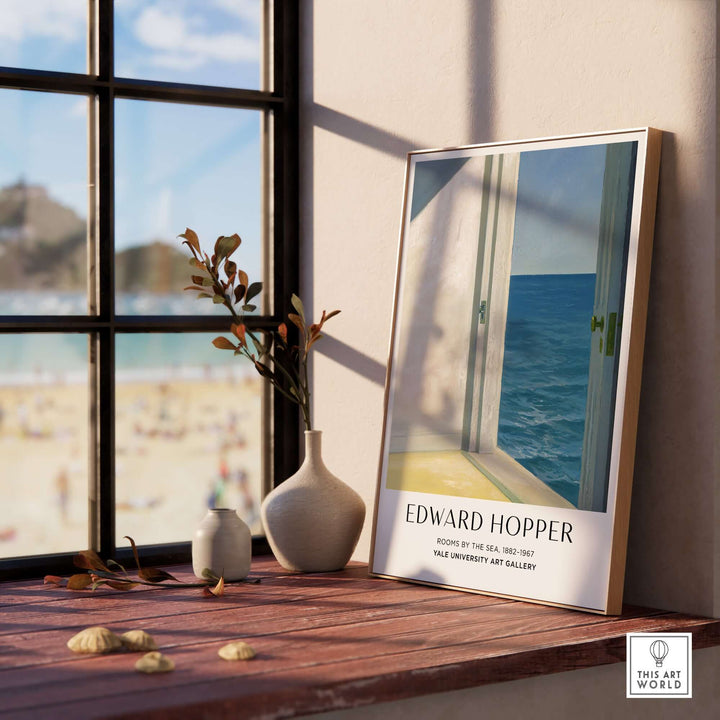 Edward Hopper Rooms by the Sea 1951 art print poster displayed on a table near a window with beach view.