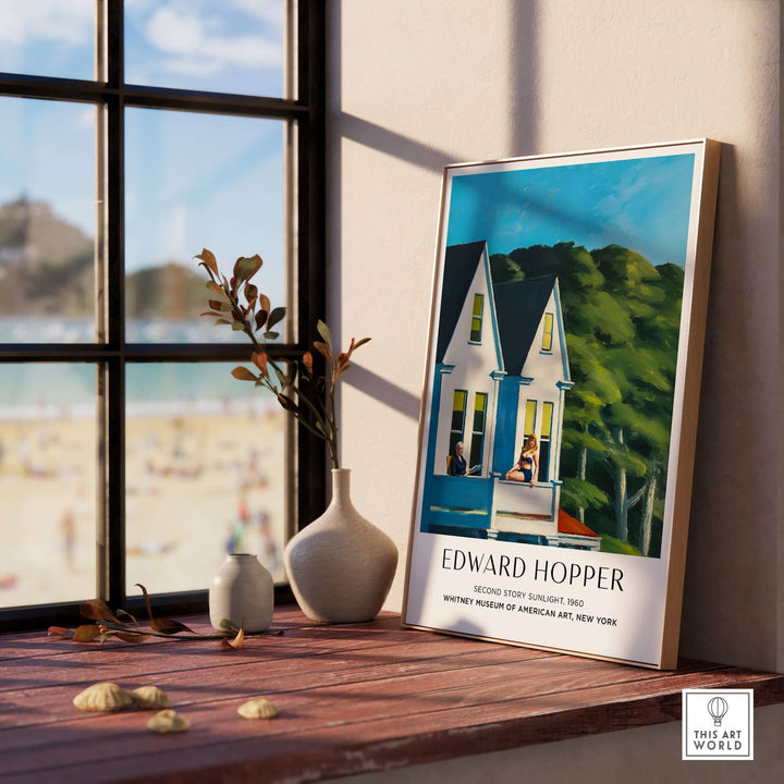 Edward Hopper's Second Story Sunlight art print displayed near a window, showcasing sunlight and figures on a balcony.