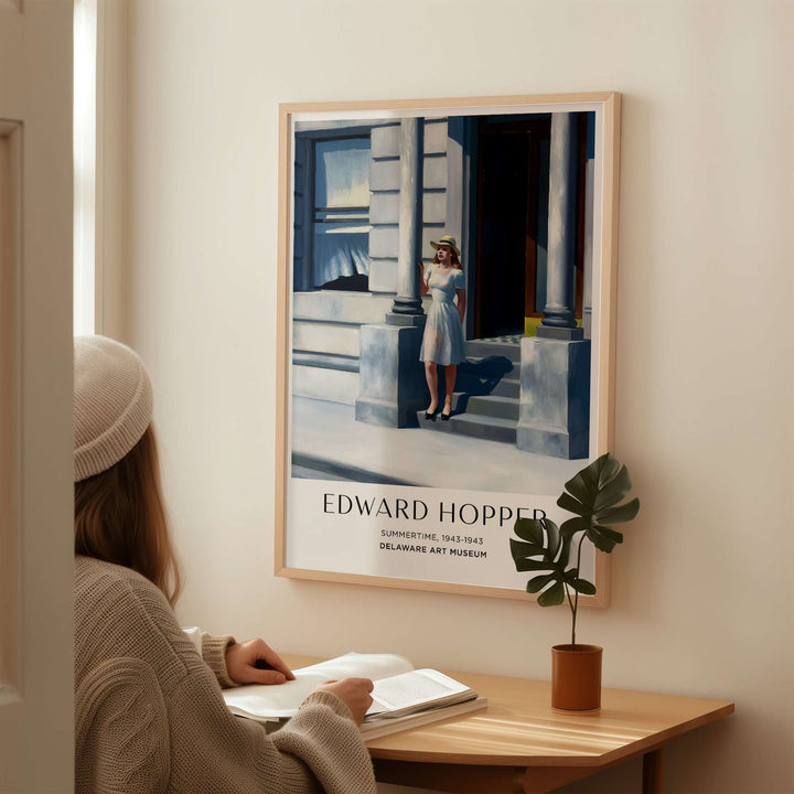 Edward Hopper Summertime 1943 art print in a stylish interior with a woman sitting at a desk.