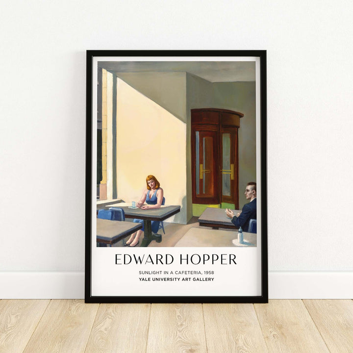 Framed print of Edward Hopper's Sunlight in a Cafeteria, showcasing light and urban isolation, Yale Art Gallery.