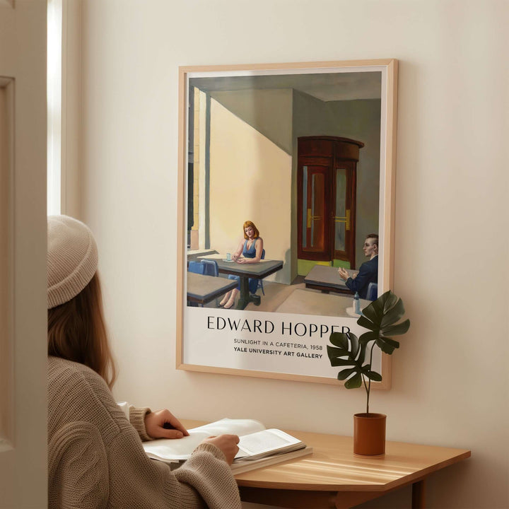 Edward Hopper Sunlight in a Cafeteria 1958 art print displayed in a cozy interior with a viewer.