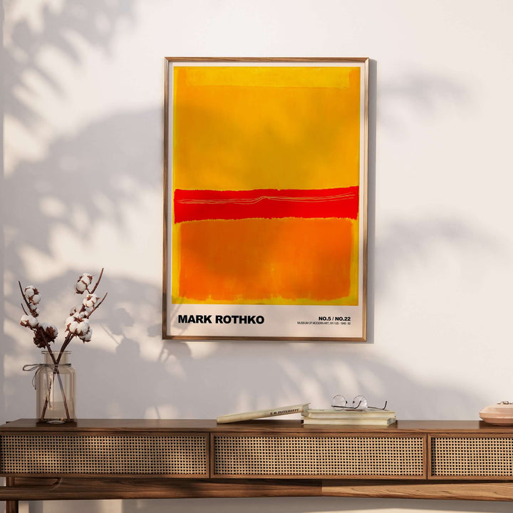 Mark Rothko No. 5 / No. 22 abstract expressionist print in vibrant red, orange, and yellow, displayed on a wall.