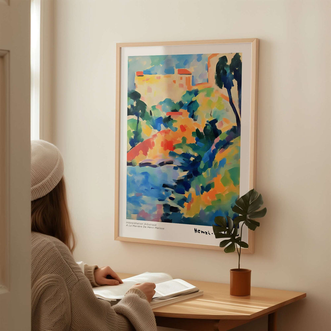 Person admiring a Matisse-inspired abstract coastal landscape poster in a cozy interior.