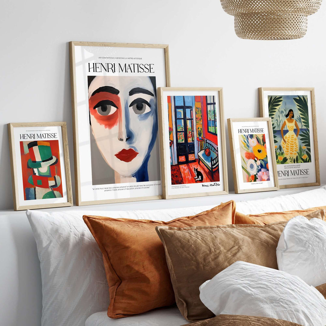 Collection of Matisse art prints featuring abstract portraits and colorful designs displayed on a modern shelf.