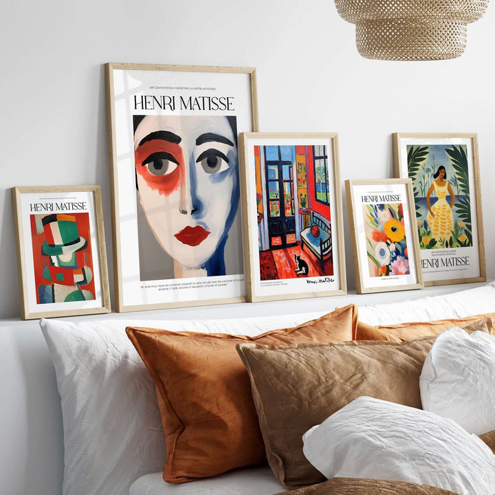 Collection of Matisse art prints featuring abstract portraits and colorful designs displayed on a modern shelf.