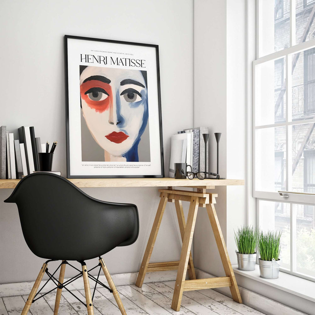 Matisse abstract face portrait print in a modern office setting with black chair and plants.