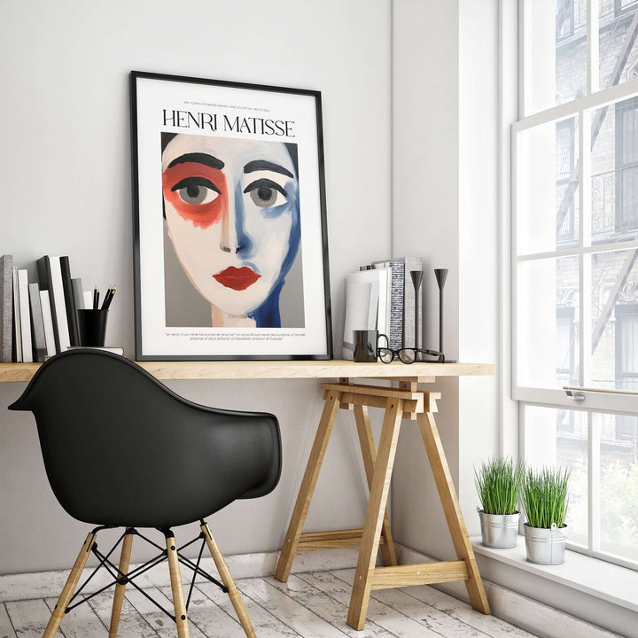 Matisse abstract face portrait print in a modern office setting with black chair and plants.