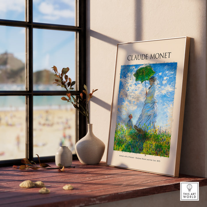 Monet art print of 'Woman with a Parasol' displayed near a window, showcasing impressionist style and vibrant colors.