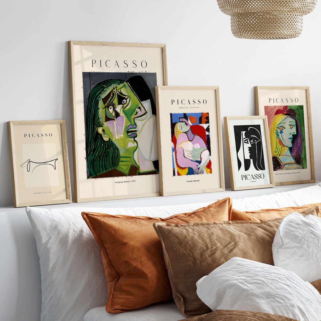 Framed Picasso art prints on a shelf, featuring Cubist portraits and emotional wall art decor.