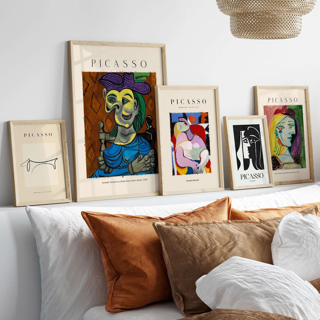 Framed Picasso art prints showcasing various styles including cubism and portraits, displayed on a white wall.