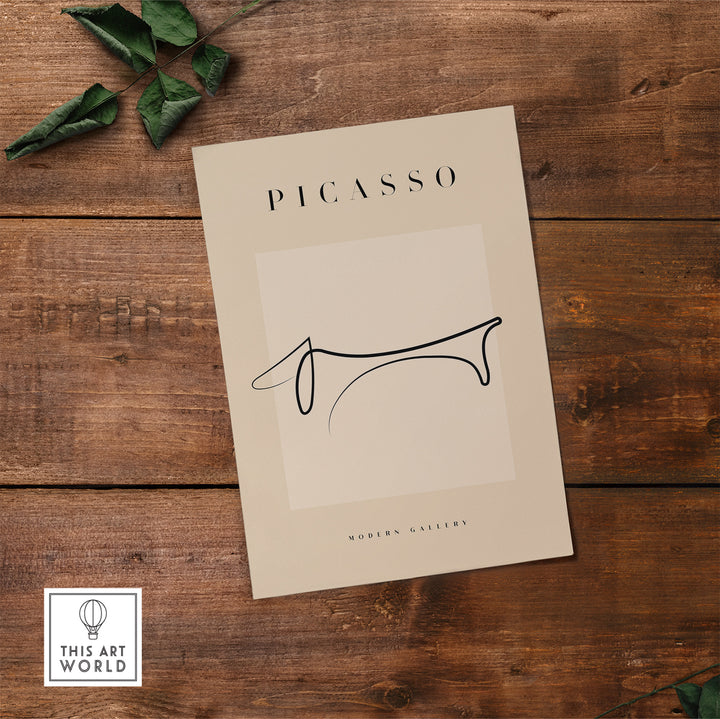 Minimalist Picasso Dachshund line art poster displayed on wooden surface, showcasing elegant simplicity.
