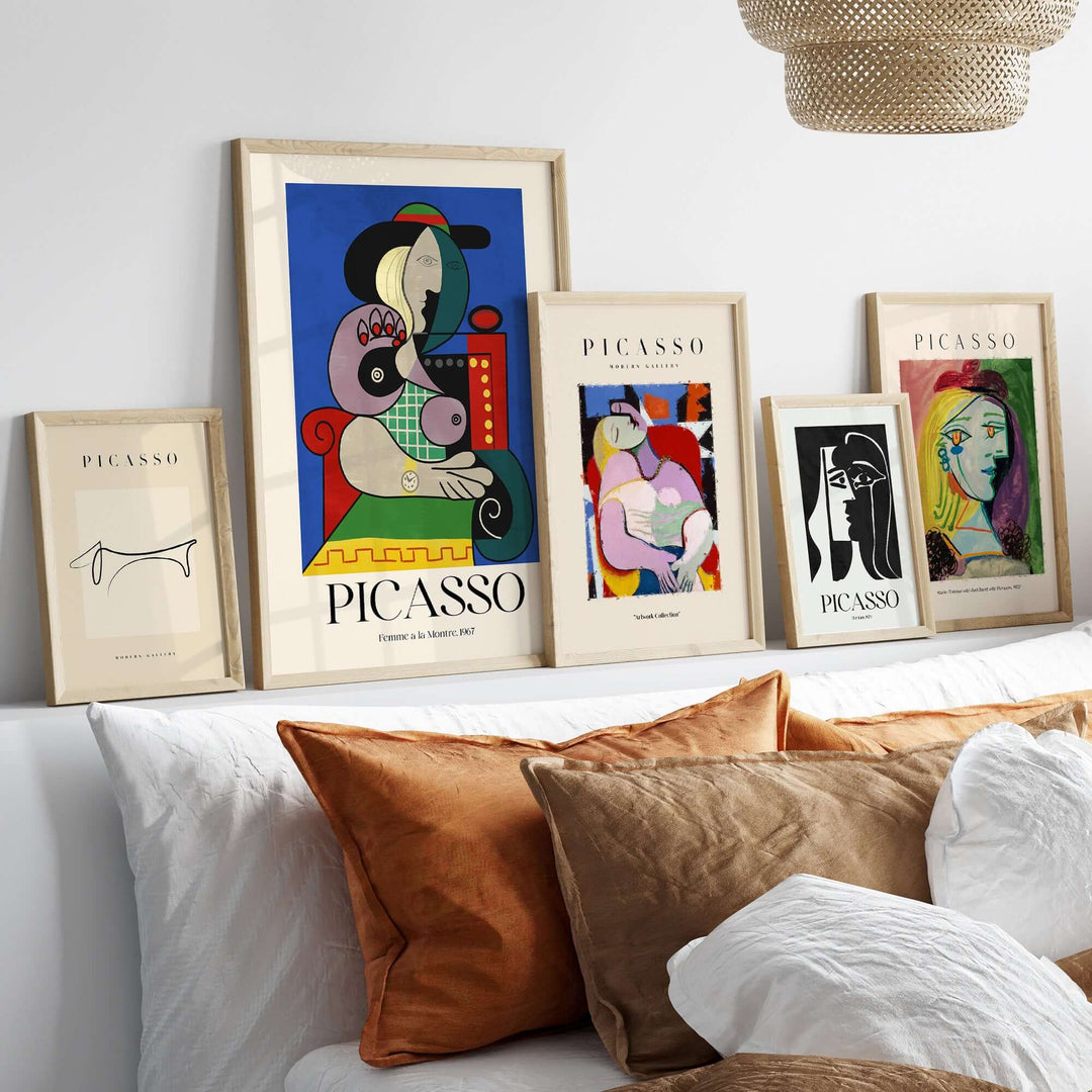 Gallery wall featuring Picasso art prints, including 'Femme à la Montre,' in stylish frames with decorative pillows.