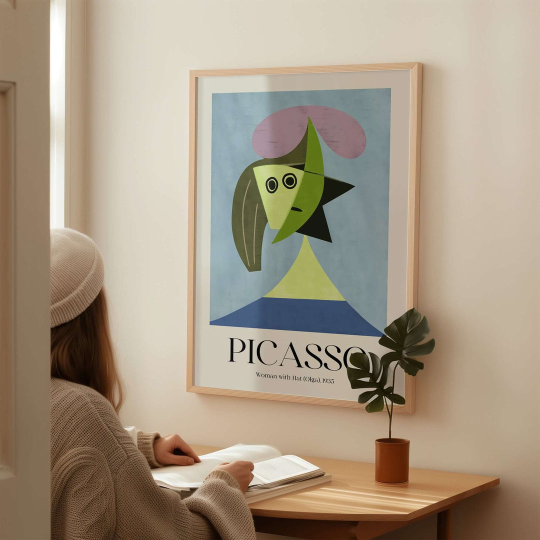 Person admiring Picasso's 'Woman with Hat (Olga)' 1935 abstract art print featuring simple shapes and vibrant colors.