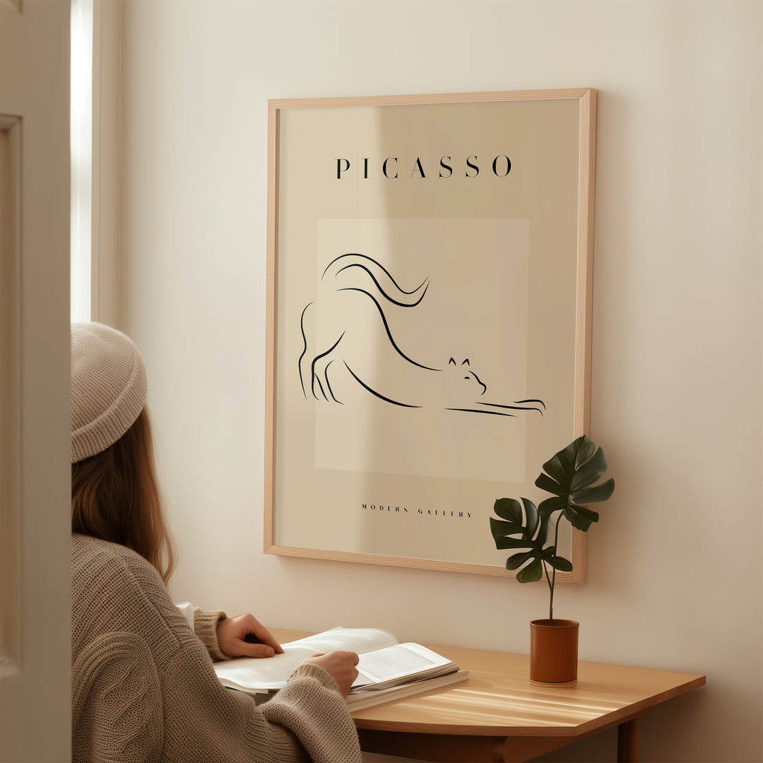 Minimalist line art poster of a stretching cat by Picasso, featured in a modern gallery setting.