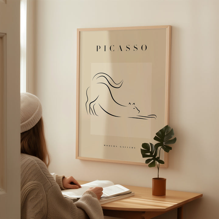 Minimalist line art poster of a stretching cat by Picasso, featured in a modern gallery setting.