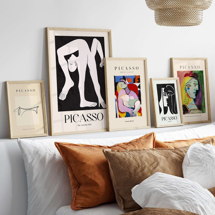 Gallery of framed Picasso art prints on a decorative shelf featuring minimalist and stylized designs.