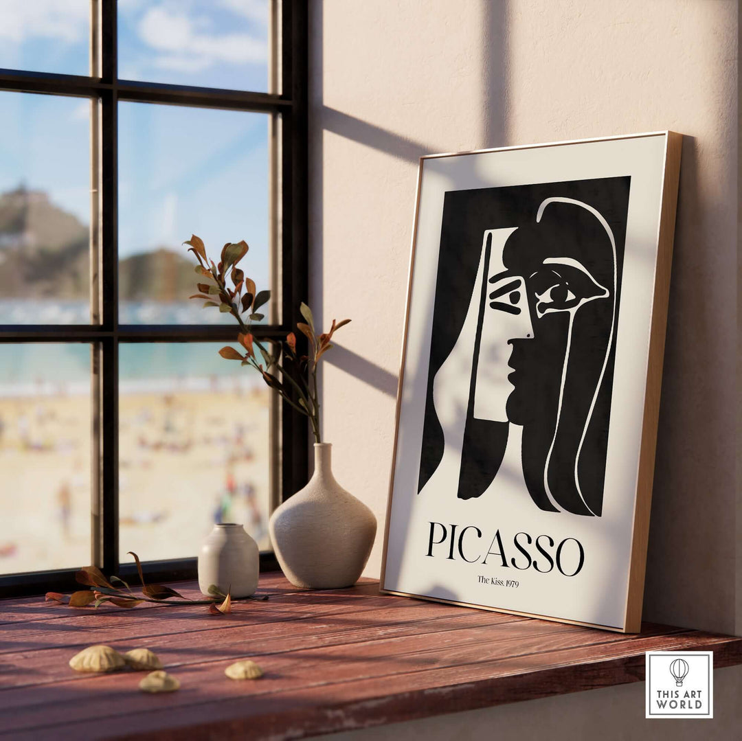 Picasso The Kiss 1979 black and white abstract art print displayed near a window with beach view.